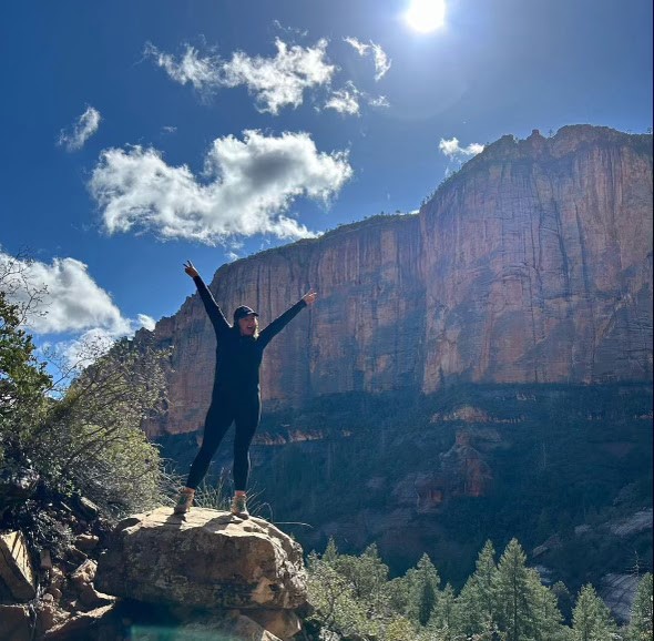 Chenoa Nickerson standing on a rock in the canyon